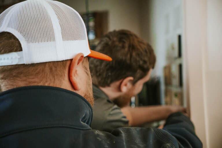 electricians reviewing wiring work on a commercial job site